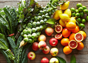 a group of fruits and vegetables on a wood surface Healthy Weight Loss Diets Huddersfield