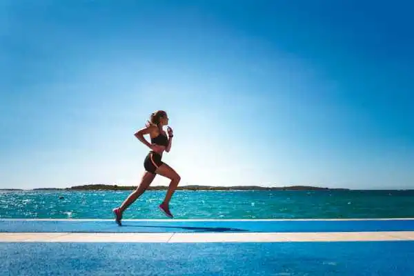 Woman running showing strong leg muscle Huddersfield